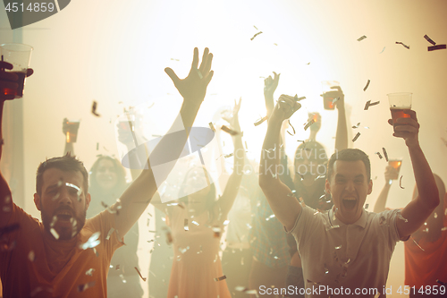 Image of Nightlife and disco concept. Young people are dancing in club.