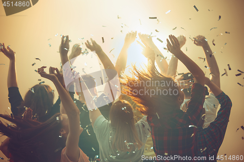 Image of Nightlife and disco concept. Young people are dancing in club.