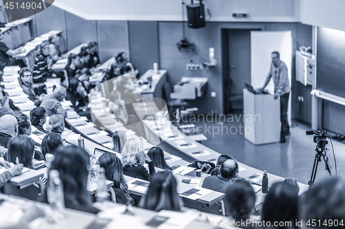 Image of Expert speaker giving a talk at scientific business conference event.