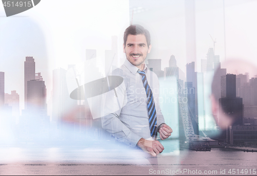 Image of Confident company leader on business meeting against new york city manhattan buildings and skyscrapers window reflection.