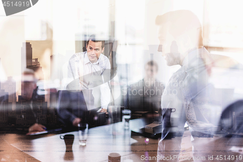 Image of Business presentation on corporate office meeting against new york city window reflections.