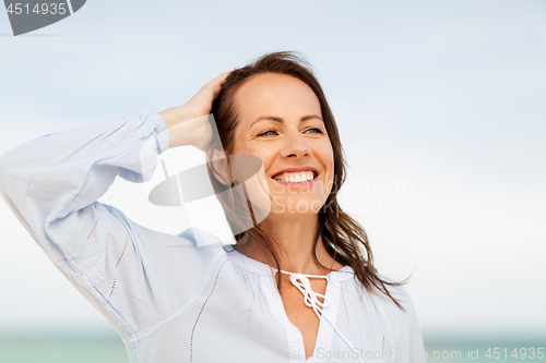 Image of happy smiling woman on summer beach