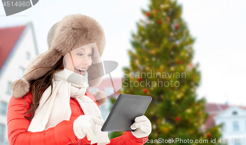 Image of woman with tablet pc over christmas tree