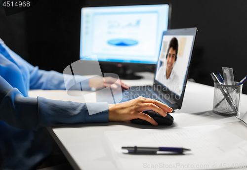 Image of businesswoman having video call on laptop at night