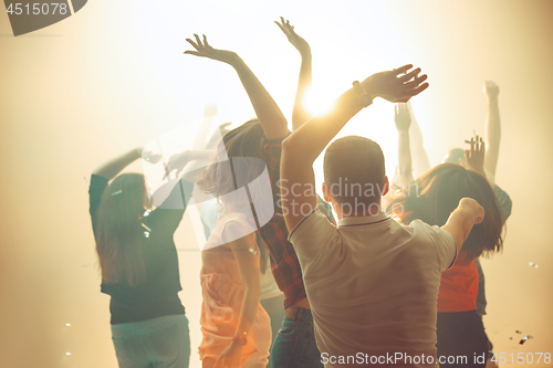 Image of Nightlife and disco concept. Young people are dancing in club.