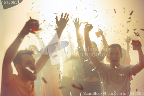 Image of Nightlife and disco concept. Young people are dancing in club.