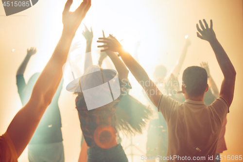 Image of Nightlife and disco concept. Young people are dancing in club.