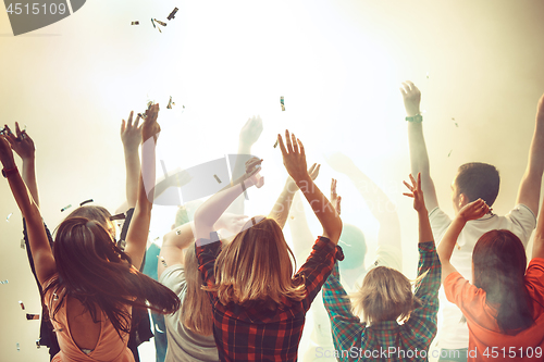 Image of Nightlife and disco concept. Young people are dancing in club.