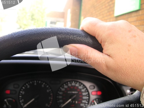 Image of hand on wheel