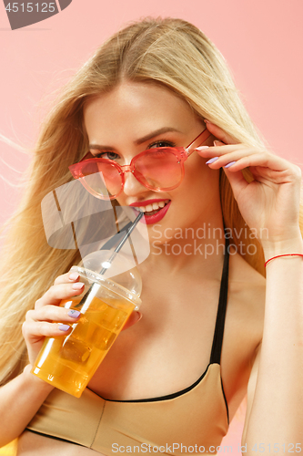 Image of Cute girl in swimsuit posing at studio. Summer portrait caucasian teenagers on pink background.
