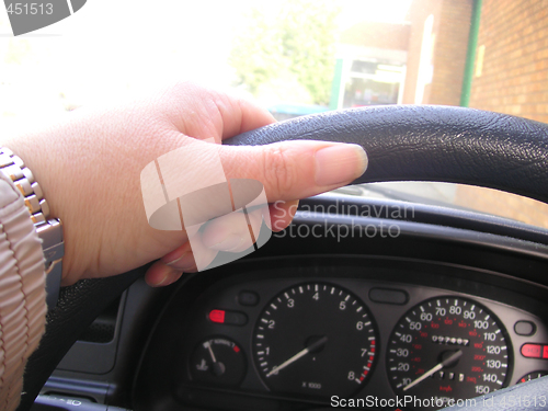 Image of left hand on steering wheel