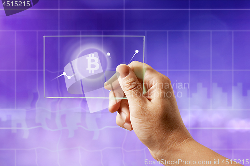 Image of Icon bitcoin on a glass screen with a graph of crypto currency on an ultraviolet background