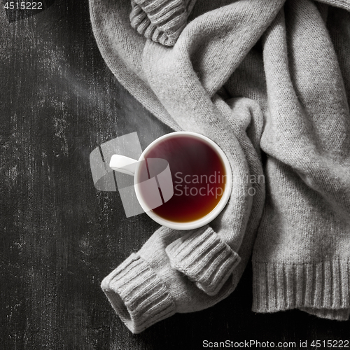 Image of knitted sweater with to cup of tea