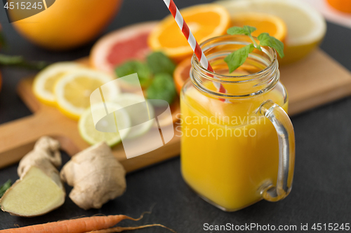 Image of mason jar glass of fruit juice on slate table top