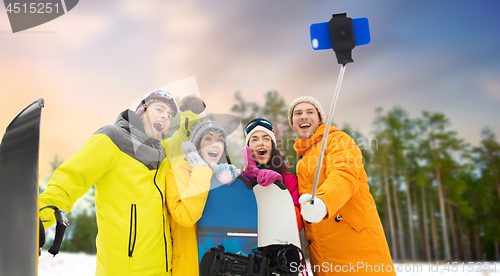 Image of happy friends with snowboards and smartphone