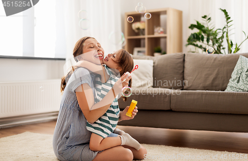 Image of pregnant mother and daughter with soap bubbles