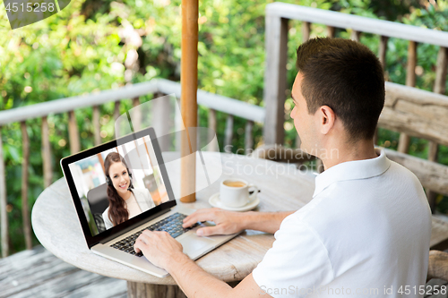 Image of man having video call with operator on laptop