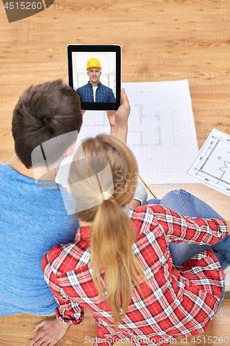 Image of couple having video call with builder