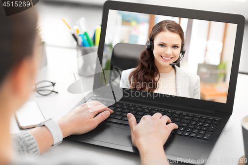 Image of woman having video call on laptop at office