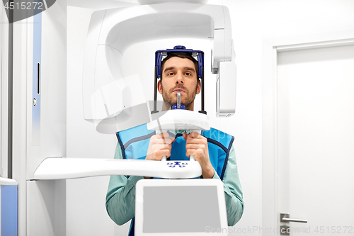 Image of patient having x-ray scanning at dental clinic