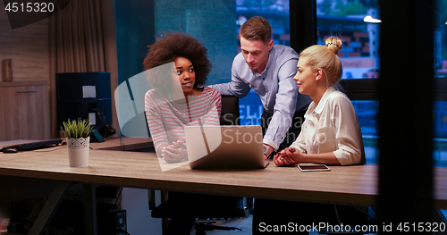 Image of Multiethnic startup business team in night office