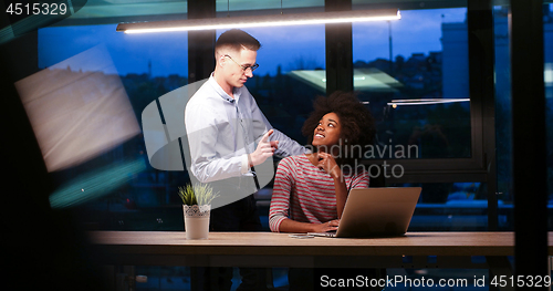 Image of Multiethnic startup business team in night office