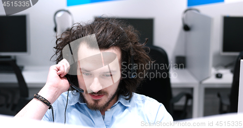 Image of male call centre operator doing his job