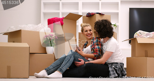 Image of young couple moving  in new house