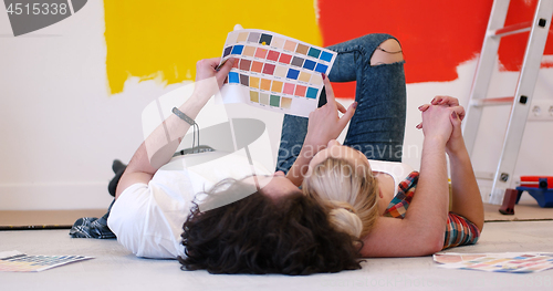 Image of Happy young couple relaxing after painting