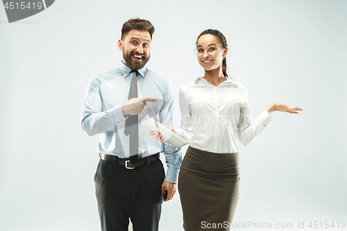 Image of a business man shows the laptop to his colleague in the office.