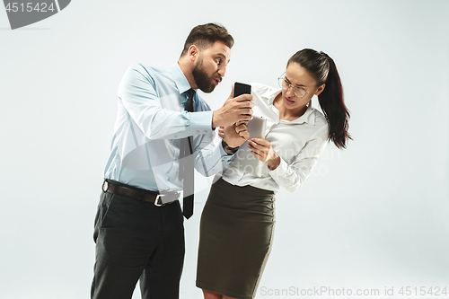 Image of angry businessman and his colleague in the office.