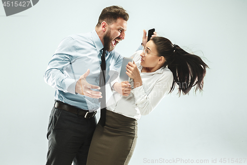 Image of angry businessman and his colleague in the office.