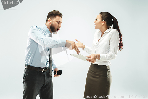 Image of a business man shows the laptop to his colleague in the office.