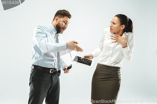 Image of a business man shows the laptop to his colleague in the office.