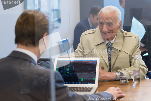 Image of Financial advisor consulting senior client with his investment strategy.