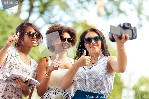 Image of women with map travelling and recording video blog