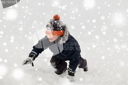 Image of happy little boy in winter clothes outdoors