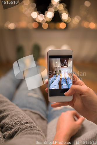 Image of close up of couple taking foot photo by smartphone