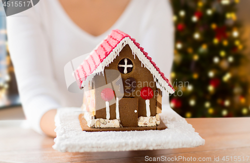 Image of close up of woman with christmas gingerbread house