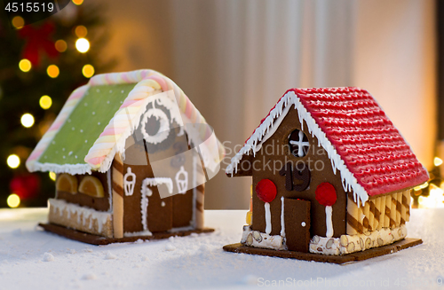 Image of gingerbread houses over christmas tree lights