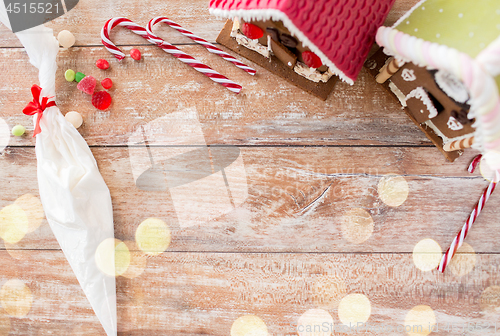 Image of christmas gingerbread houses on wooden background