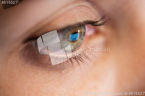 Image of close up of woman eye looking at computer screen