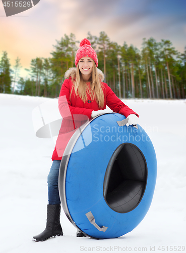 Image of happy teenage girl with snow tube in winter