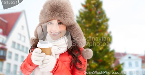 Image of woman with coffee over christmas tree in tallinn
