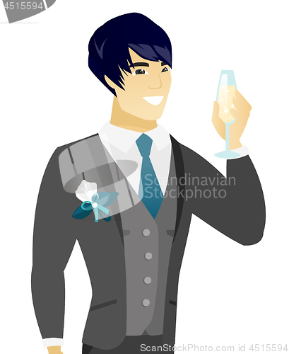 Image of Young asian groom holding glass of champagne.