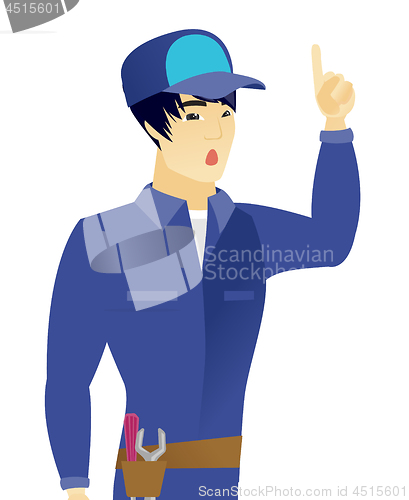 Image of Asian mechanic with open mouth pointing finger up.