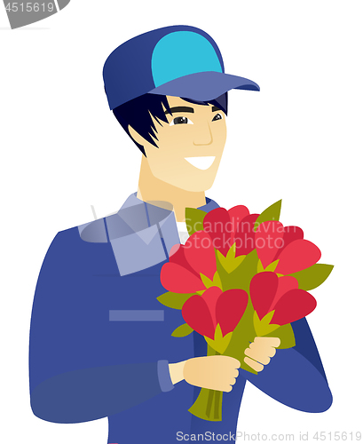 Image of Young asian mechanic holding a bouquet of flowers