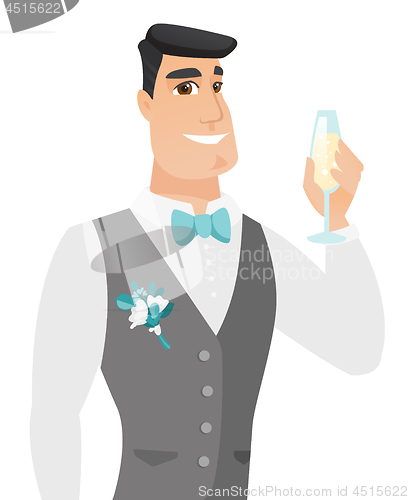 Image of Young caucasian groom holding glass of champagne.