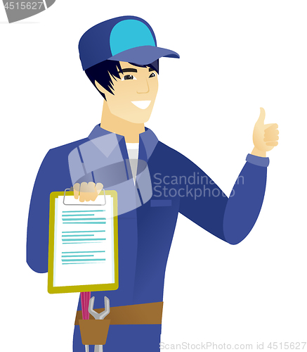 Image of Asian mechanic with clipboard giving thumb up.