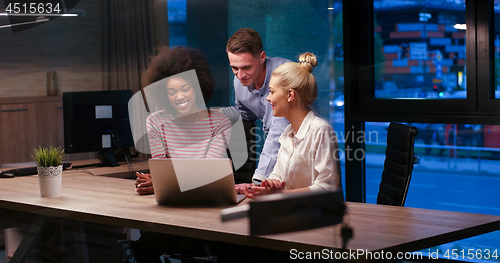 Image of Multiethnic startup business team in night office